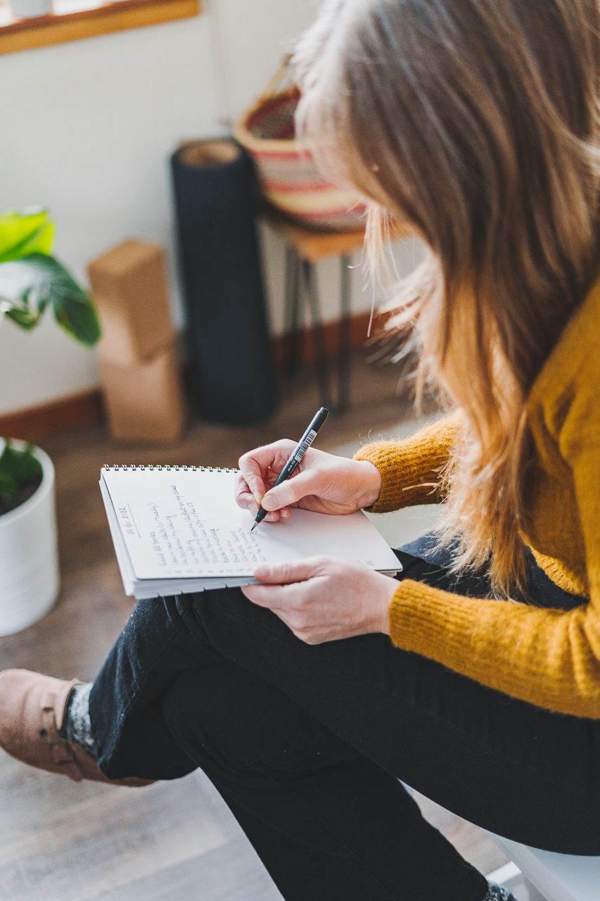 Chloé writing a list of 2022 resolutions by Conscious by Chloé