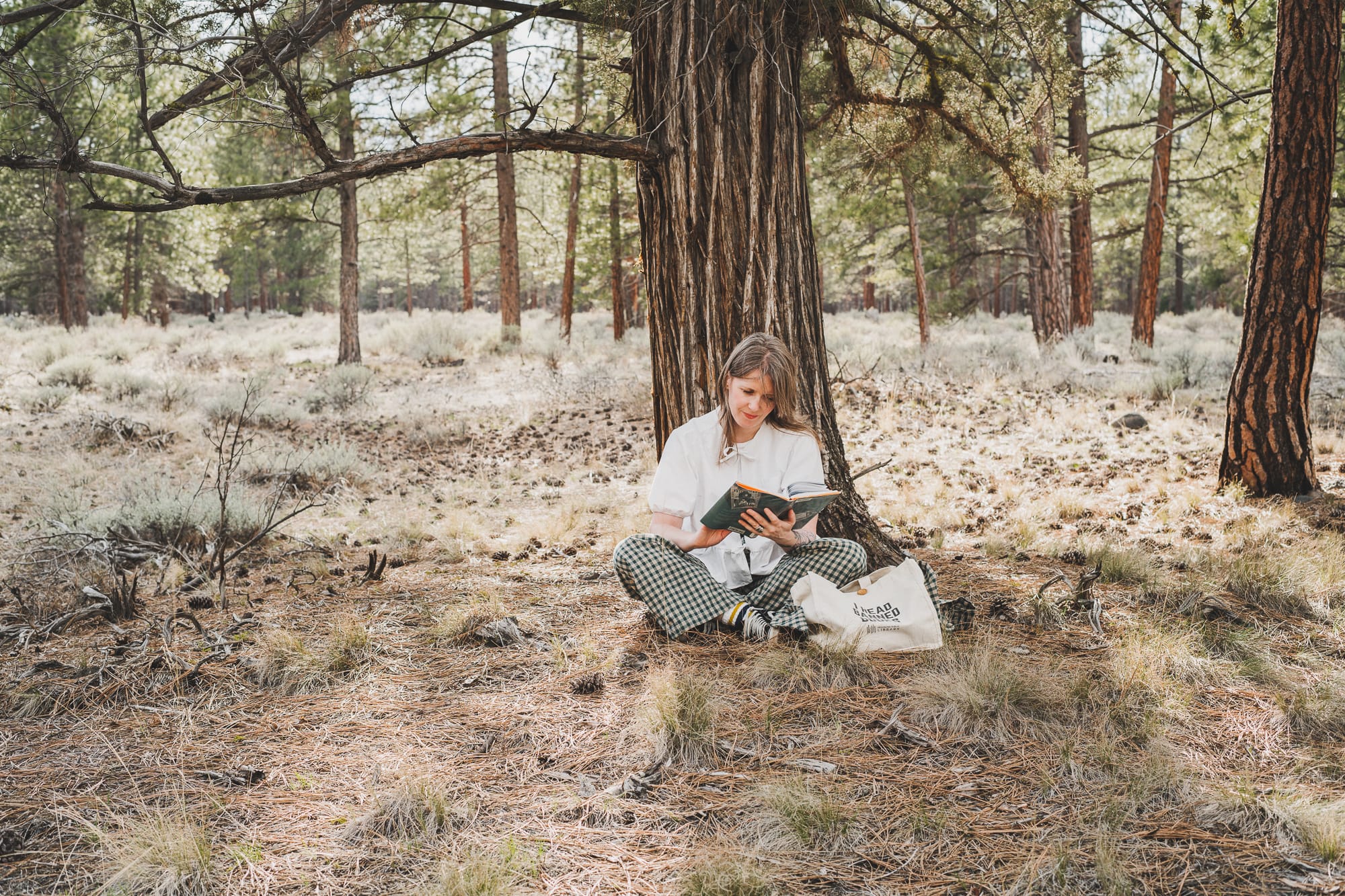 Chloé reading a banned book in the forest