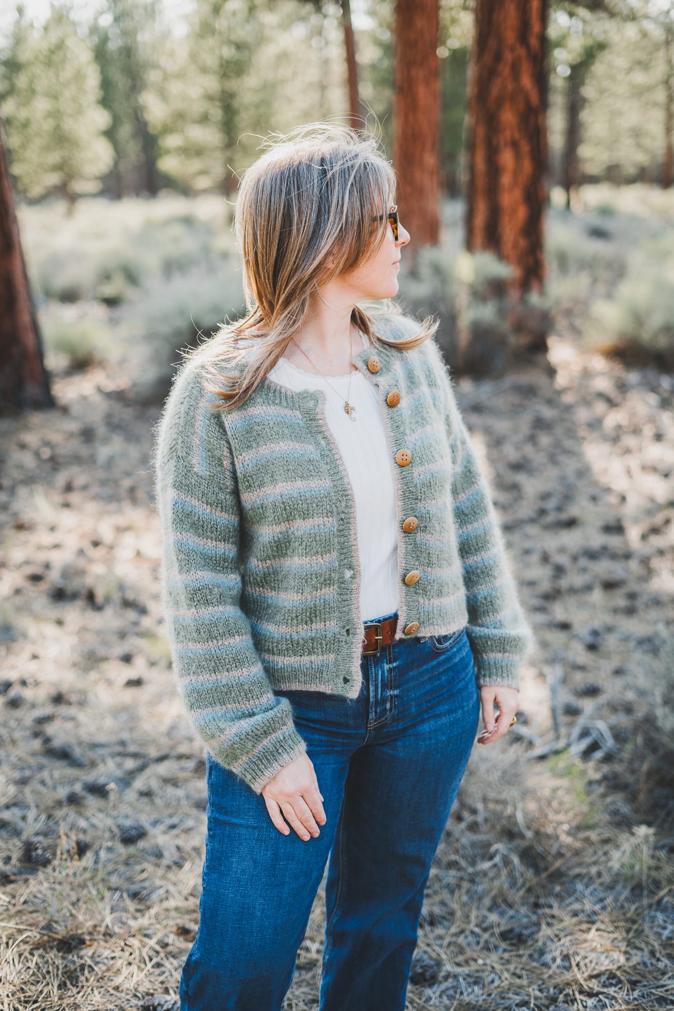 Chloé wearing the Wool and the Gang Piece of Me Cardigan in colors latte green and blue