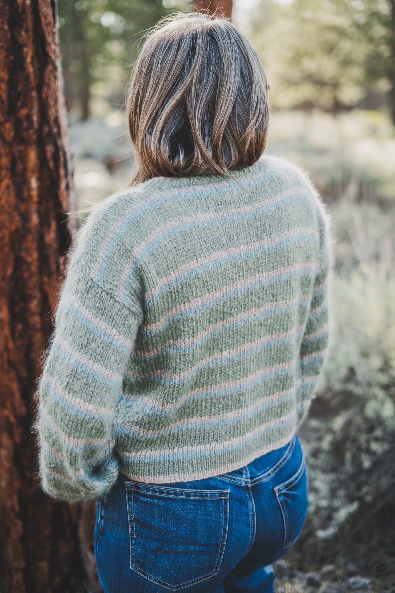Back of the Wool and the Gang Piece of Me Cardigan in colors latte green and blue