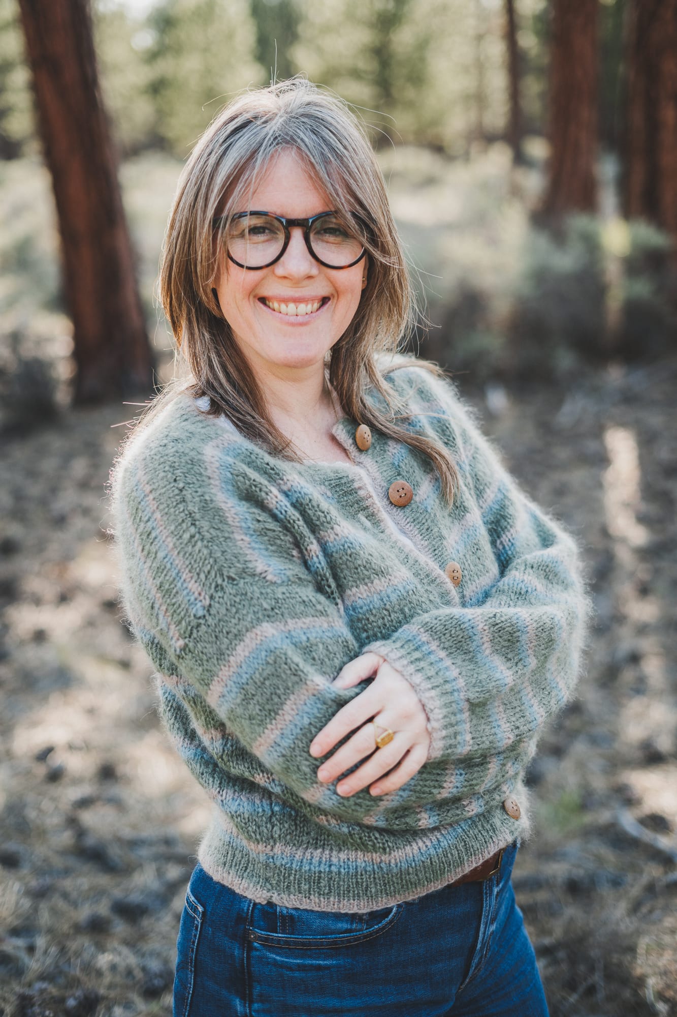 Chloé wearing her Wool and the Gang Piece of Me Cardigan in colors latte green and blue